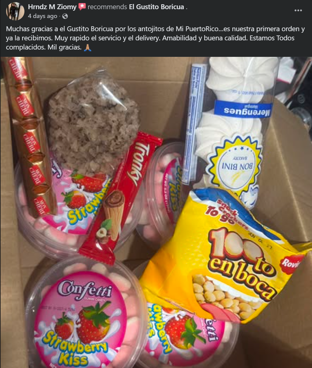 A cardboard gift box filled with assorted Spanish candies and snacks, including a bag of strawberry soft candies, a red Funni candy stick, a yellow bag of 100% en boca peanuts, pink strawberry kiss candies, and a clear container of brown sugar or chocolate chunks. The photo is taken from above inside the box, with a social media post visible at the top.